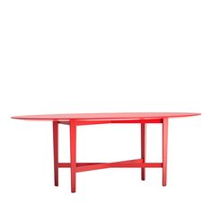 a red table sitting on top of a white wall