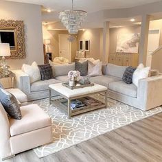 a living room filled with furniture and a chandelier