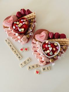 two valentine's day cakes on display with scrabbles and love letters