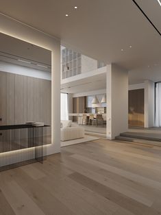 an empty living room with wooden floors and white furniture in the center is lit by recessed lights