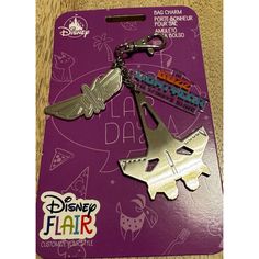 a pair of metal scissors on top of a purple card with the words disney flair