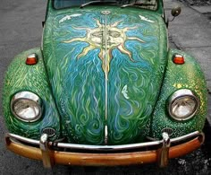 an old beetle painted with green and blue swirls