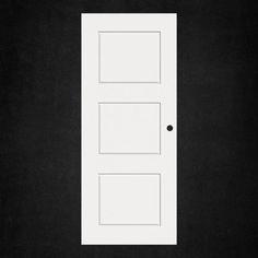 a white door on a black wall