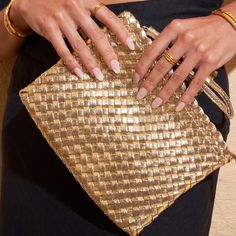 Day or night, our Lavinia Clutch is the magical new accessory of the season! The perfect size for your everyday style, or easy to throw into your big beach bag, this soft and stylish clutch is a must have this summer season! CARE GUIDE CARING FOR YOUR AOE JEWELS  At Arms Of Eve, we take great pride in the quality of all our jewels. All of our pieces are suitable for daily wear. Our jewels are 100% nickel and lead free. All our pieces are plated 2 microns thick in 18k Gold, as well as an e-coatin Summer Gold Clutch For Everyday Use, Gold Clutch For Everyday Summer Use, Gold Summer Travel Clutch, Luxury Gold Straw Bag For Travel, Summer Party Bags With Braided Handles, Gold Shoulder Bag With Removable Pouch For Summer, Summer Gold Clutch Shoulder Bag, Gold Handheld Clutch For Summer, Gold Clutch Shoulder Bag For Summer