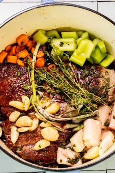 a pot filled with meat and vegetables on top of a table