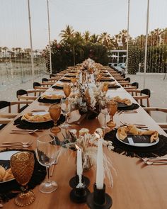 a long table set with place settings for dinner