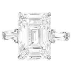 This exquisite ring is a true masterpiece, centered around a stunning 3.01 carat emerald cut diamond, meticulously certified by the GIA to guarantee its superior quality and authenticity. The diamond boasts an E color grade, exuding a crisp, near colorless brilliance that captures light beautifully, while its VVS2 clarity ensures remarkable purity, with only minute inclusions visible under magnification. These features make it a diamond of exceptional rarity and beauty. Crafted with Excellent Po Large Diamond Rings, Emerald Cut Diamond Engagement Ring, Emerald Cut Diamond Engagement, Emerald Cut Diamond Ring, Barbie Model, Platinum Diamond Rings, Bracelet Love, Modern Engagement Rings, Three Stone Diamond