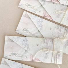 four wedding envelopes tied with twine