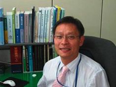 a man sitting in an office chair with a tie on