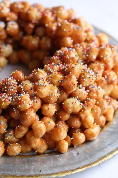 a close up of a plate of food with sprinkles on it and the words homemade strufoli