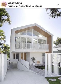 an image of a house with white walls and balconies