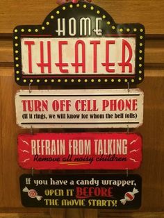 a sign that says home theater on the side of a door with other signs attached to it