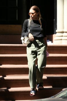 a woman is walking down some steps