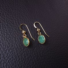 "Genuine, Bezeled Colombian Emerald Earrings DESCRIPTION Beautiful, vibrant green Emerald Gemstones with unique rustic markings and brilliant sparkle. Displayed in an elegant bezel design setting of your choice of metal: 14k Gold Filled or 925 Sterling Silver. Suspended graciously from french ear wire with shiny gold ball accent matching metal. Perfectly dainty and elegant yet noticeable enough to be seen shimmer from across the room. EMERALD DETAILS * Genuine Rustic Emerald Earrings {2 size opt Handmade Round Emerald Earrings, May Birthstone Drop Earrings With Ear Wire, Handmade Emerald Drop Earrings, Handmade Emerald Teardrop Earrings, Handmade Emerald Earrings As Gift, Handmade Emerald Earrings For Gift, Emerald Teardrop Gemstone Earrings, Teardrop Emerald Gemstone Earrings, Emerald Gemstone Earrings As Gift