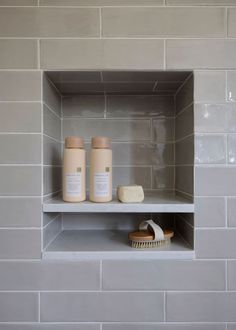 the shelves in this bathroom are filled with soaps and toothbrushes on them