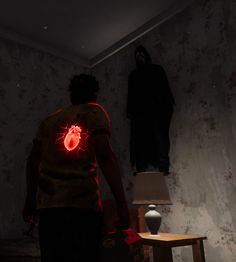 a man standing in front of a mirror with a red light on his chest and another person behind him