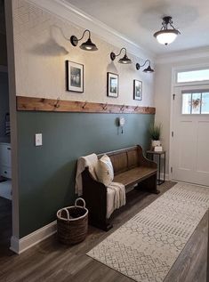 a wooden bench sitting in the middle of a living room next to a white door