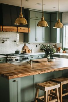 a kitchen with green cabinets and wooden stools in front of the island countertop