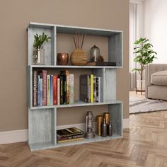 a book shelf with books and vases on it