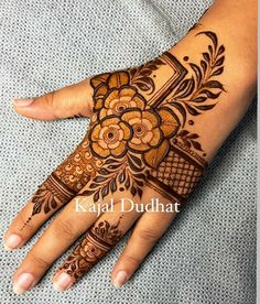 the hand is decorated with henna and flowers