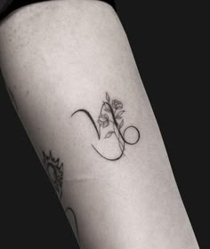 a woman's leg with a flower tattoo on the left side of her thigh