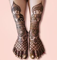 the legs and feet of a woman with henna tattoos