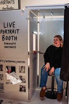 a woman sitting on a stool in front of a booth for live portrait booth 3 portraits