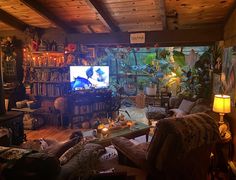 a living room filled with lots of furniture and a flat screen tv mounted to the wall