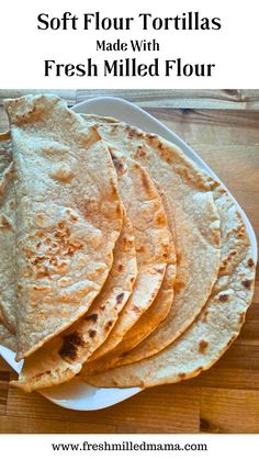 fresh flour tortillas on a plate with text overlay that reads soft flour tortillas made with fresh milled flour