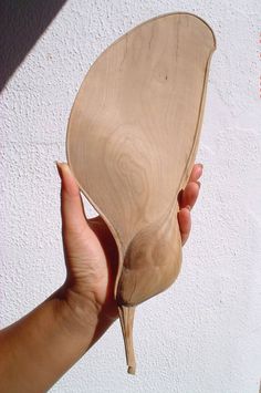 a person holding a wooden object in their hand