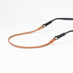 Our extra slim Flywire style is the perfect leather sunglass strap for the minimalist. Handmade from full grain vegetable tanned leather. Individually stitched, edge dyed, and buffed. Safe to get wet. One size fits all frames (including Costa and Wayfarers). Patented soft rubber connectors secured with brass rivet. Proudly handmade in the USA. US Patents 11,209,666 & 11,782,292. Sunglass Strap, Sunglasses Strap, The Other Guys, Monogrammed Leather, Soft Rubber, Sunglass Frames, Vegetable Tanned Leather, Full Grain Leather, Tan Leather