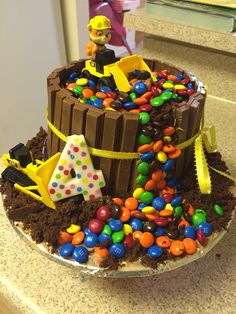 a birthday cake made to look like a construction site with chocolate icing and candy