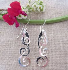 Curlicue Drops Modern Twist Silver Teardrop Jewelry, Elegant Spiral Jewelry For Gifts, Elegant Sterling Silver Jewelry With Artistic Design, Modern Twist Metal Jewelry For Gifts, Modern Twist Metal Jewelry As A Gift, Artistic Dangle Jewelry As Gift, Artistic Dangle Jewelry For Gifts, Elegant Handmade Swirl Earrings, Modern Metal Jewelry As Gift