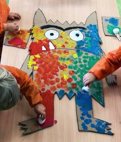 two children are making an animal out of construction paper