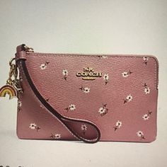 Coach Ditsy Daisy Print And Charms -Printed Coated Canvas -Two Credit Card Slots -Zip Top Closure -Fabric Lining -Wrist Strap Attached 6 1/4” (L)X4”(H) Packaged In A Coach Gift Box Pink Pouch Wristlet For Spring, Spring Pink Pouch Wristlet, Trendy Wristlet With Zipper Pouch, Trendy Pink Wristlet For Spring, Spring Coach Rectangular Wristlet, Coach Spring Rectangular Wristlet, Spring Pouch Wristlet With Zipper Closure, Spring Rectangular Coach Wristlet, Spring Wristlet With Zipper Closure In Pouch Shape