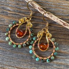 Wire Wrapped African Turquoise Beaded Hoop Dangle Earrings with Carnelian and a Nickel Free Ear-Wire: These earrings are wrapped with copper and are light weight, comfortable, simple and fun. Throw them on with any outfit and they will definitely add some pop. Perfect for the holidays! They are approximately 1.85 inches in length and 1 inch at the widest portion.  All of these items are handmade so please allow for possible slight variance in sizing. If you would like these in a different color Earth Tone Jewelry, Dreamy Fashion, Jewelry Magic, Jewelry Rustic, Hoop Dangle Earrings, Carnelian Earrings, Original Jewelry Design, Rustic Earrings, Bijoux Fil Aluminium