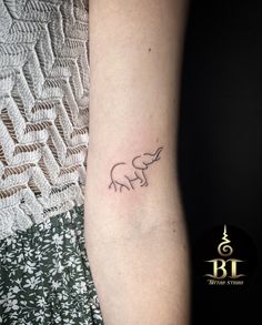 a small elephant tattoo on the arm