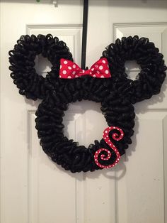 a minnie mouse wreath hanging on the front door