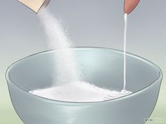 a person pouring sugar into a large bowl