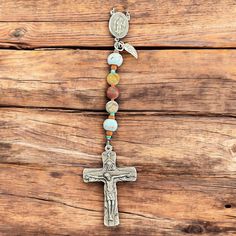 This exquisite handcrafted rosary honors St. Isidore the Farmer, patron saint of farmers, laborers, and rural communities. Each carefully selected element reflects the earthly and divine aspects of St. Isidore's life, creating a powerful tool for prayer and meditation. The Hail Mary beads are the browns and greens of natural Picasso Jasper and the Our Fathers are glazed terra cotta clay with a light blue glaze. The solid pewter centerpiece features St. Isidore, and the Holy Trinity Crucifix, in oxidized silver, made in Italy, celebrates God The Father, The Son, and The Holy Spirity. Below the centerpiece hangs a sterling silver angel wing and throughout the Rosary are earthy terra cotta seed beads. Handmade Artisan Rosary, Handmade Spiritual Rosary, Spiritual Crucifix Rosary For Blessing, Handmade Spiritual Rosary With Crucifix, St Isidore The Farmer, Terra Cotta Clay, The Holy Trinity, Handmade Tapestries, Santa Fe Style