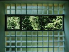 an open window with trees in the background