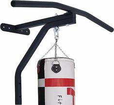 a red and white punching bag hanging from a hook on a black metal wall mount