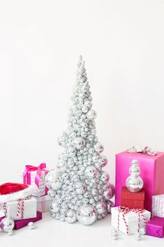 a white christmas tree surrounded by presents and boxes with the words holiday diys that are so elevated