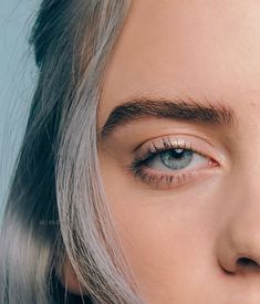 a woman with grey hair and blue eyes