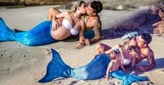 two women and a man are laying on the beach with mermaid tail tails in front of them