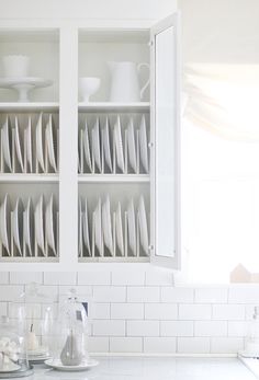 a kitchen counter with plates and cups on it