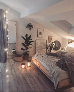 a bed room with a neatly made bed and some lights on the wall next to it