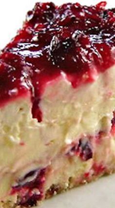 a piece of cheesecake with cranberry sauce on top