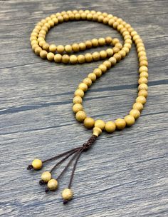 A mala is a string of 108 beads used in meditation to keep count of a mantra and to help silence the mind. Repeating the mantra of your choosing introduces positive thought patterns and redirects your mind from daily obsessions and distractions. Mala beads have been used for centuries in a variety of spiritual traditions. Boxwood is associated with dreams, redirecting the mind in a more peaceful, productive direction. Also enhances endurance and helps ward of negative energy. Bead Size: 8mm Spiritual Wooden Beads Jewelry For Meditation, Spiritual Wooden Beads Necklace For Meditation, Spiritual Wooden Beads Mala For Meditation, Spiritual Necklace With 108 Natural Beads, Spiritual Mala With 108 Beads For Blessing, Holistic Healing Mala With Wooden Beads, Spiritual Natural Jewelry For Meditation, Natural Spiritual Jewelry For Meditation, 108 Spiritual Beads For Meditation