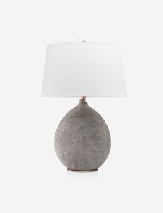 a gray table lamp with a white shade on it